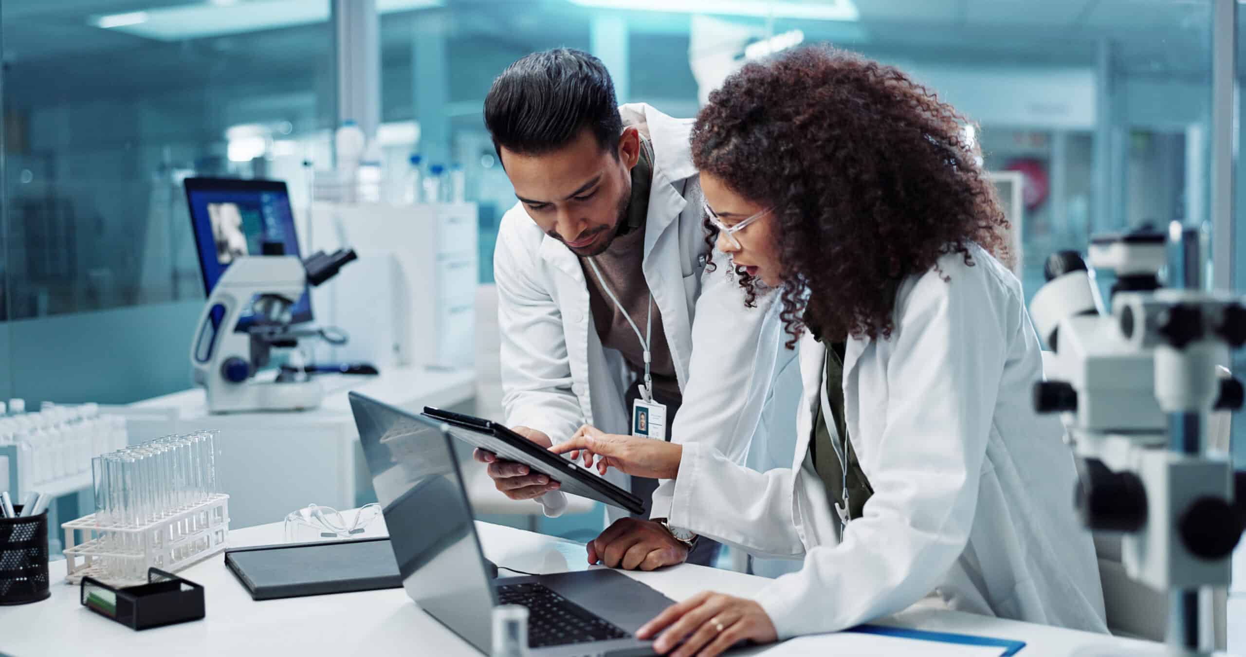 teamwork and scientist with tablet in laboratory for communicatio