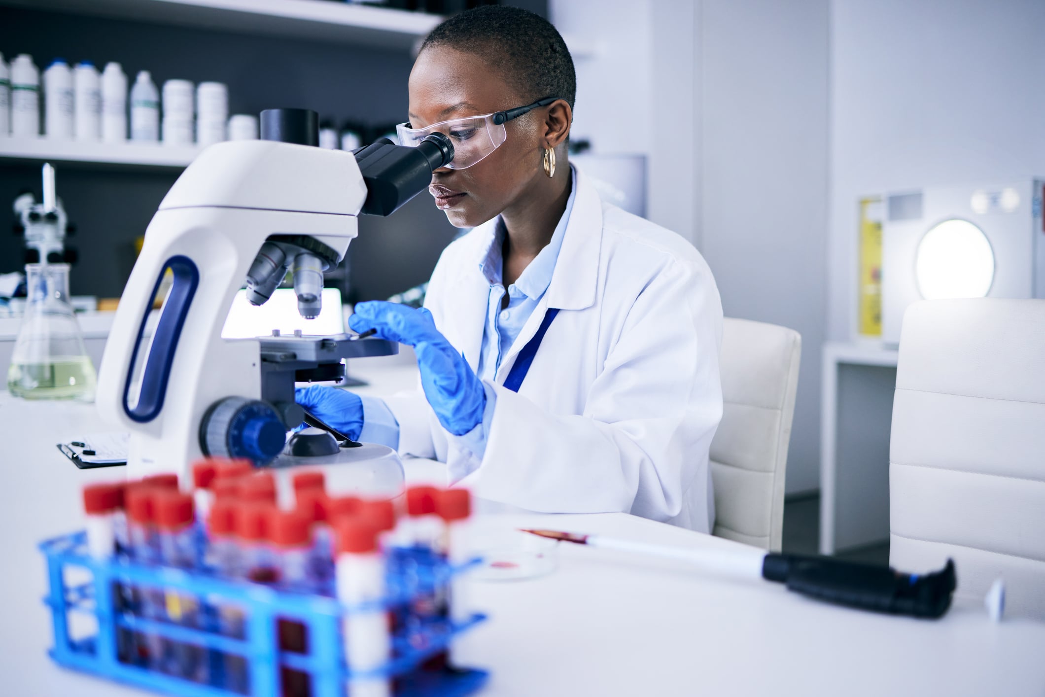 Science, laboratory and woman on microscope