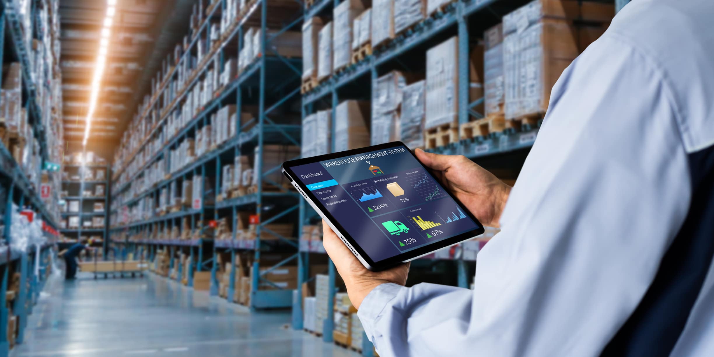 Manager using digital tablet,showing warehouse software management dashboard